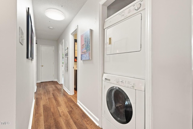 2322 Stroller Ave, Durham, NC 27705 - laundry area with stacked washer / drying machine, wood finished floors, and a textured ceiling