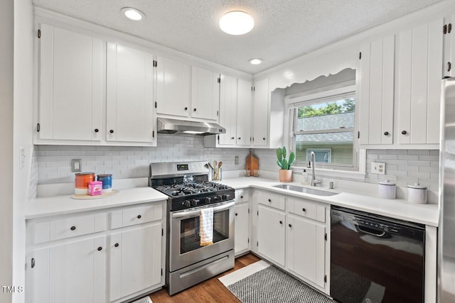 2322 Stroller Ave, Durham, NC 27705 - kitchen featuring dishwasher, gas range, under cabinet range hood, a textured ceiling, and white cabinets