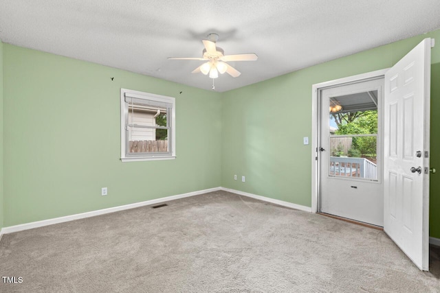2322 Stroller Ave, Durham, NC 27705 - carpeted empty room featuring healthy amount of natural light, ceiling fan, and a textured ceiling