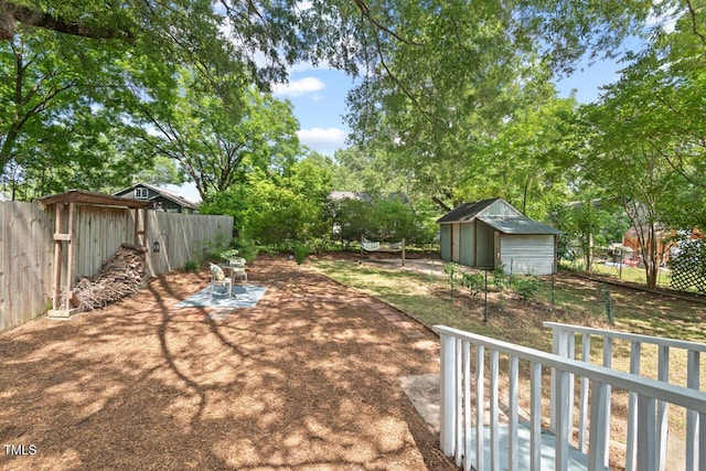 2322 Stroller Ave, Durham, NC 27705 - fenced backyard with a patio and a storage unit