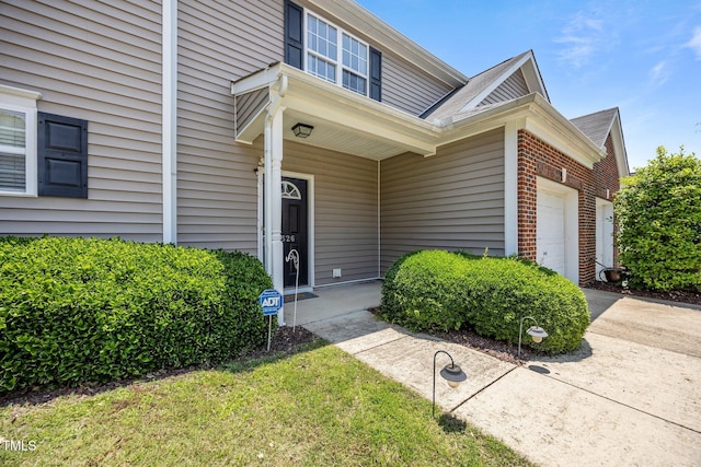 3526 Londonville Ln, Raleigh, NC 27604 - property entrance with brick siding, an attached garage, driveway, and a shingled roof