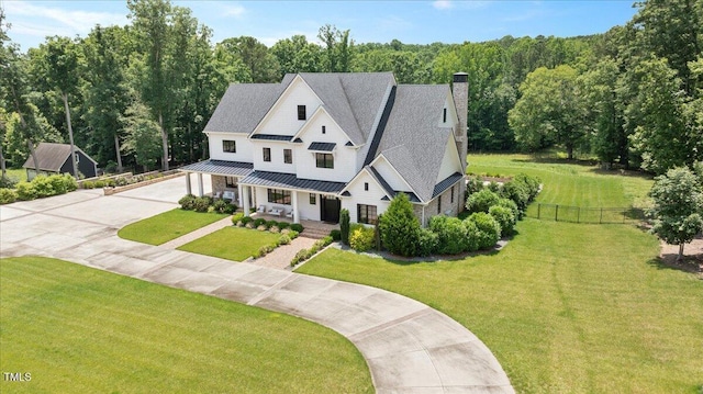 2508 Kearney Rd, Wake Forest, NC 27587 - modern farmhouse with a porch, driveway, a standing seam roof, a chimney, and a metal roof