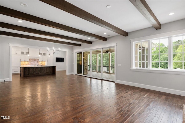 2508 Kearney Rd, Wake Forest, NC 27587 - unfurnished living room with a chandelier, beamed ceiling, and dark wood-style floors