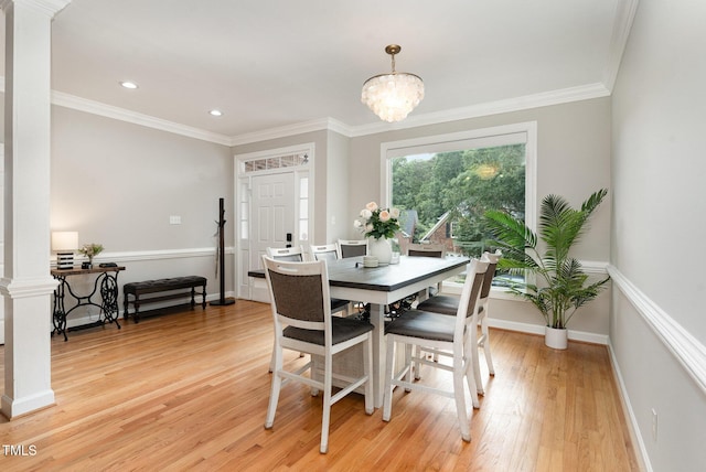 6313 Belle Crest Dr, Raleigh, NC 27612 - dining area with light wood-type flooring, a chandelier, recessed lighting, crown molding, and decorative columns