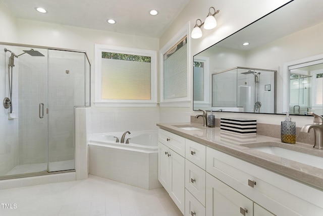 6313 Belle Crest Dr, Raleigh, NC 27612 - full bathroom with a shower stall, a garden tub, double vanity, tile patterned floors, and recessed lighting