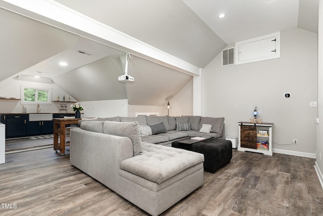 6313 Belle Crest Dr, Raleigh, NC 27612 - living area with vaulted ceiling, wood finished floors, and recessed lighting