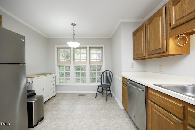 146 Greenmont Ln, Cary, NC 27511 - kitchen featuring stainless steel appliances, ornamental molding, brown cabinets, light countertops, and decorative light fixtures