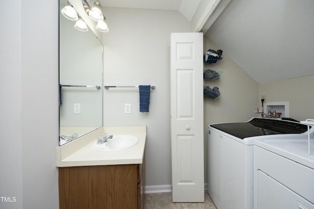 146 Greenmont Ln, Cary, NC 27511 - bathroom with washing machine and dryer, lofted ceiling, and vanity