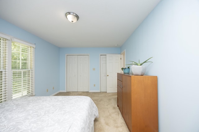 146 Greenmont Ln, Cary, NC 27511 - bedroom featuring two closets and light carpet