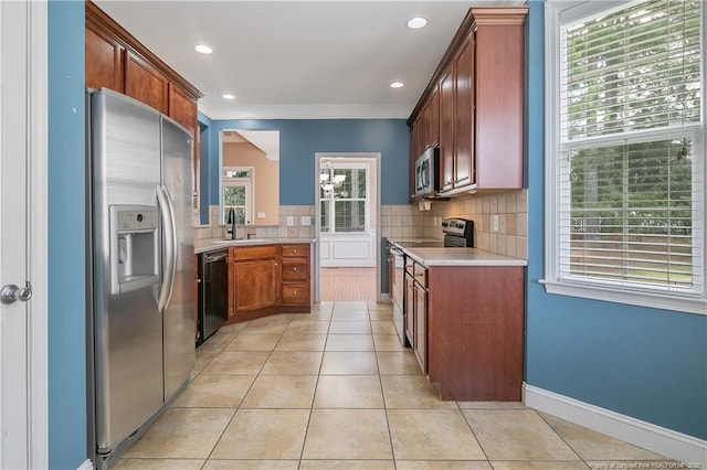 177 Lamplighter Way, Spring Lake, NC 28390 - kitchen with stainless steel appliances, light countertops, light tile patterned flooring, tasteful backsplash, and a sink