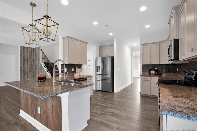 66 S Hawks Ridge Ln, Smithfield, NC 27577 - kitchen featuring appliances with stainless steel finishes, a sink, a peninsula, dark stone countertops, and tasteful backsplash