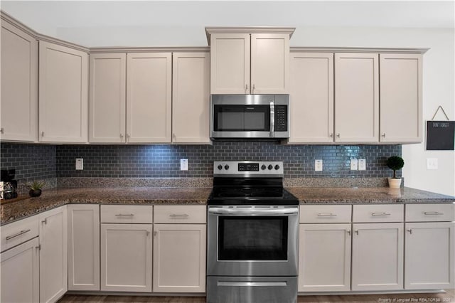 66 S Hawks Ridge Ln, Smithfield, NC 27577 - kitchen with stainless steel appliances, decorative backsplash, and dark stone countertops