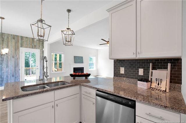 66 S Hawks Ridge Ln, Smithfield, NC 27577 - kitchen featuring dishwasher, a sink, a warm lit fireplace, dark stone counters, and open floor plan