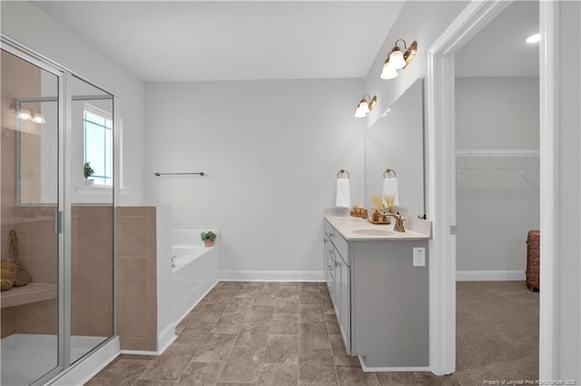 66 S Hawks Ridge Ln, Smithfield, NC 27577 - full bathroom with vanity, a stall shower, a bath, a walk in closet, and baseboards