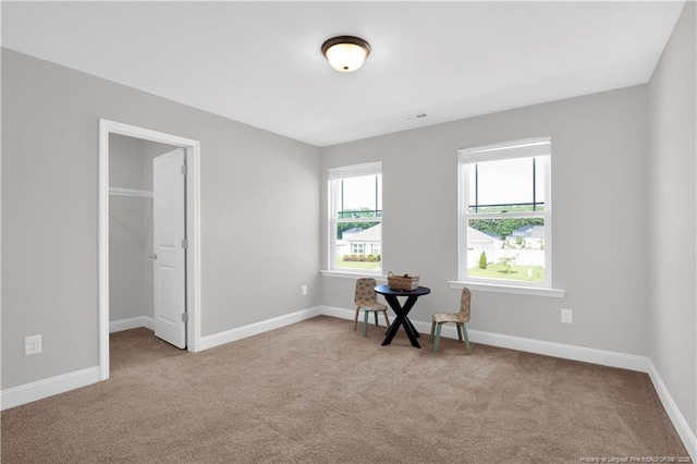 66 S Hawks Ridge Ln, Smithfield, NC 27577 - carpeted bedroom with a walk in closet and baseboards