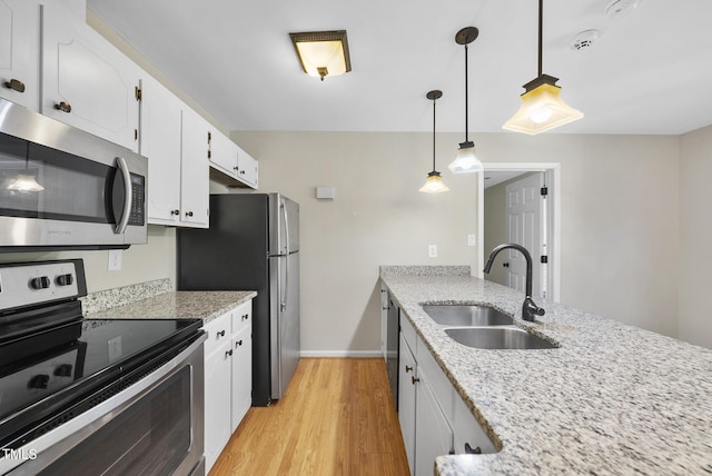 3427 Mill Run, Raleigh, NC 27612 - kitchen with stainless steel appliances, a sink, white cabinetry, light wood finished floors, and baseboards