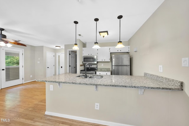 3427 Mill Run, Raleigh, NC 27612 - kitchen with appliances with stainless steel finishes, a peninsula, a kitchen breakfast bar, and a sink