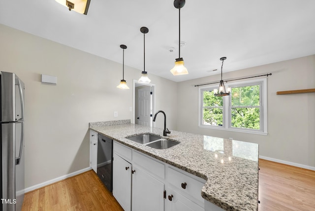 3427 Mill Run, Raleigh, NC 27612 - kitchen featuring freestanding refrigerator, a sink, black dishwasher, a peninsula, and light wood-type flooring