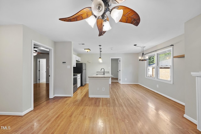 3427 Mill Run, Raleigh, NC 27612 - kitchen with a chandelier, a ceiling fan, appliances with stainless steel finishes, light wood-type flooring, and baseboards