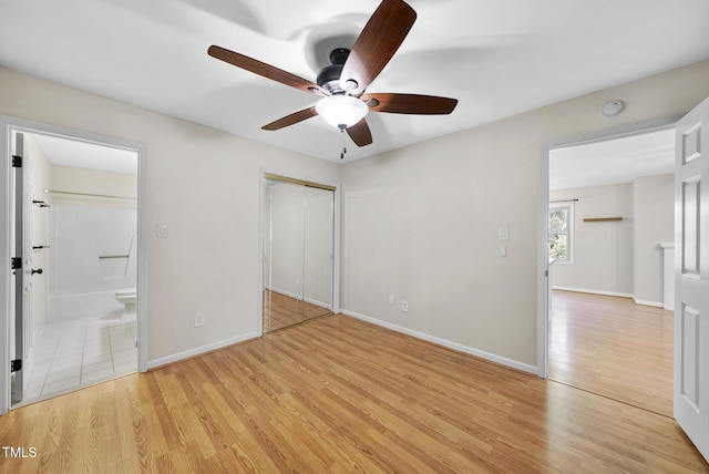 3427 Mill Run, Raleigh, NC 27612 - unfurnished bedroom featuring light wood finished floors, ensuite bath, a closet, baseboards, and ceiling fan