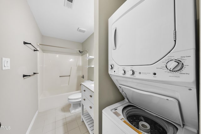 3427 Mill Run, Raleigh, NC 27612 - bathroom with stacked washer / dryer, toilet, tile patterned flooring, bathing tub / shower combination, and baseboards