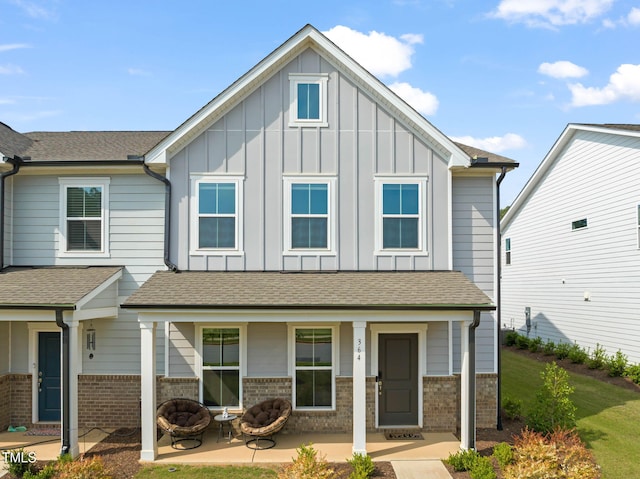 364 Abbots Mill Dr, Raleigh, NC 27603 - view of front of property featuring board and batten siding, brick siding, and an outdoor fire pit