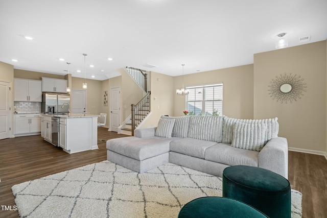 364 Abbots Mill Dr, Raleigh, NC 27603 - living room with dark wood-style flooring, a chandelier, stairway, and recessed lighting