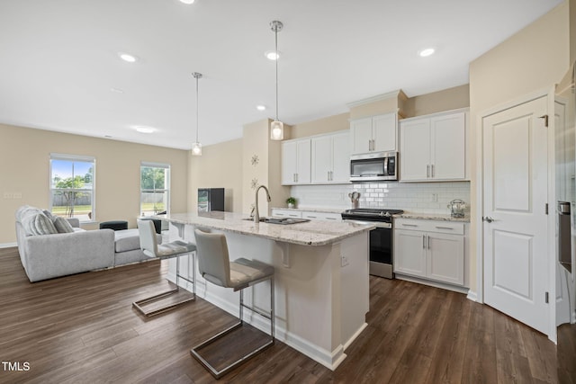 364 Abbots Mill Dr, Raleigh, NC 27603 - kitchen with stainless steel appliances, decorative backsplash, white cabinets, dark wood-style flooring, and recessed lighting