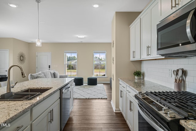 364 Abbots Mill Dr, Raleigh, NC 27603 - kitchen featuring stainless steel appliances, dark wood-style floors, tasteful backsplash, decorative light fixtures, and open floor plan