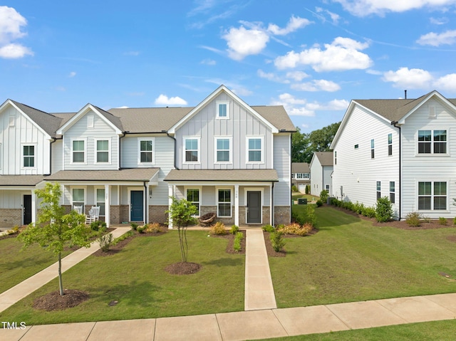364 Abbots Mill Dr, Raleigh, NC 27603 - townhome / multi-family property with board and batten siding, covered porch, and a front yard