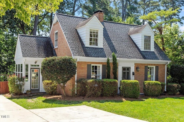 1100 Brooks Ave, Raleigh, NC 27607 - cape cod house featuring a chimney, roof with shingles, brick siding, and a front yard