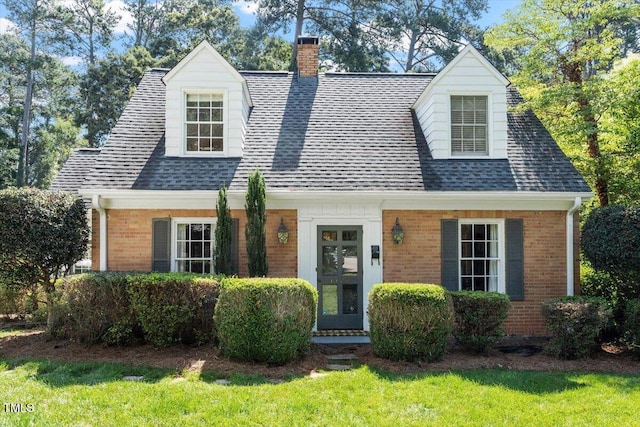 1100 Brooks Ave, Raleigh, NC 27607 - cape cod home with brick siding, a chimney, roof with shingles, and a front yard