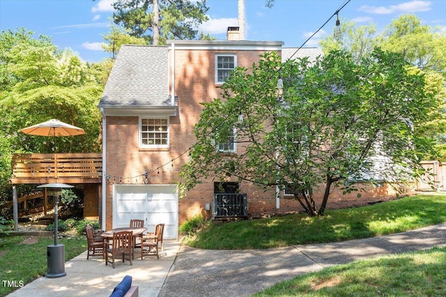 1100 Brooks Ave, Raleigh, NC 27607 - view of front of house with brick siding, an attached garage, a chimney, and a patio area