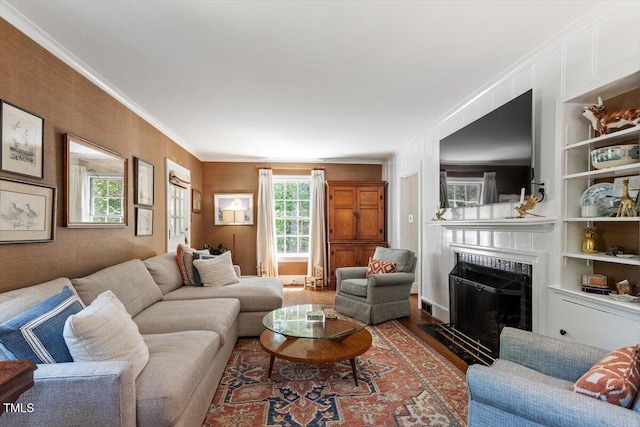 1100 Brooks Ave, Raleigh, NC 27607 - living area with ornamental molding, wood finished floors, a fireplace with flush hearth, and built in shelves
