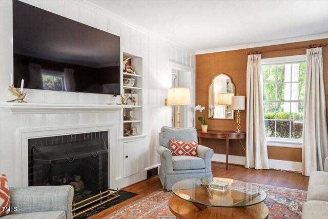 1100 Brooks Ave, Raleigh, NC 27607 - living room featuring ornamental molding, wood finished floors, and a fireplace