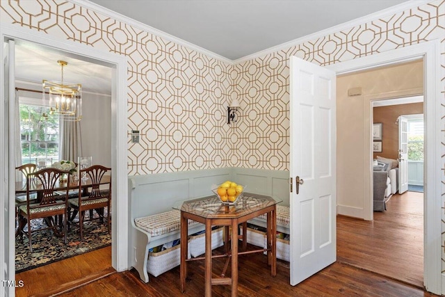 1100 Brooks Ave, Raleigh, NC 27607 - dining space featuring wallpapered walls, a chandelier, ornamental molding, dark wood finished floors, and a wainscoted wall