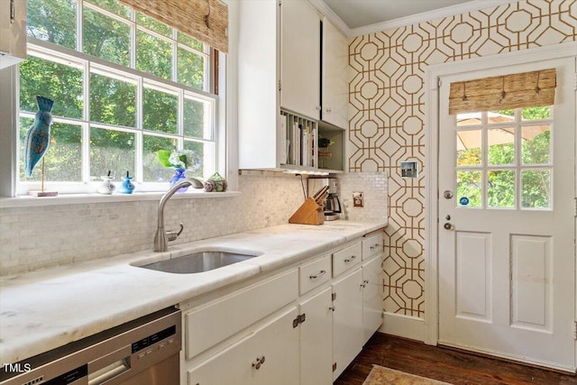 1100 Brooks Ave, Raleigh, NC 27607 - kitchen featuring dishwasher, crown molding, white cabinetry, light countertops, and plenty of natural light