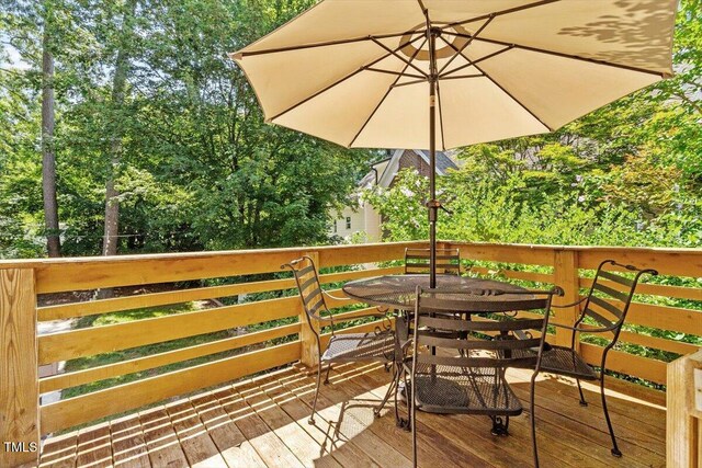 1100 Brooks Ave, Raleigh, NC 27607 - wooden terrace with outdoor dining area and view of wooded area
