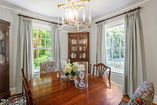1100 Brooks Ave, Raleigh, NC 27607 - dining area with a chandelier, plenty of natural light, ornamental molding, and wood finished floors