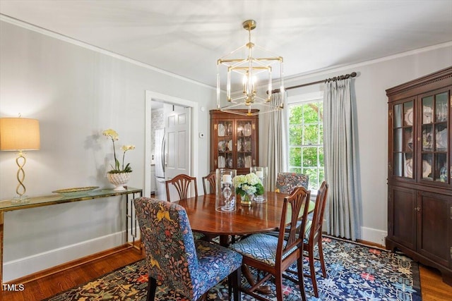 1100 Brooks Ave, Raleigh, NC 27607 - dining room featuring a chandelier, wood finished floors, and ornamental molding