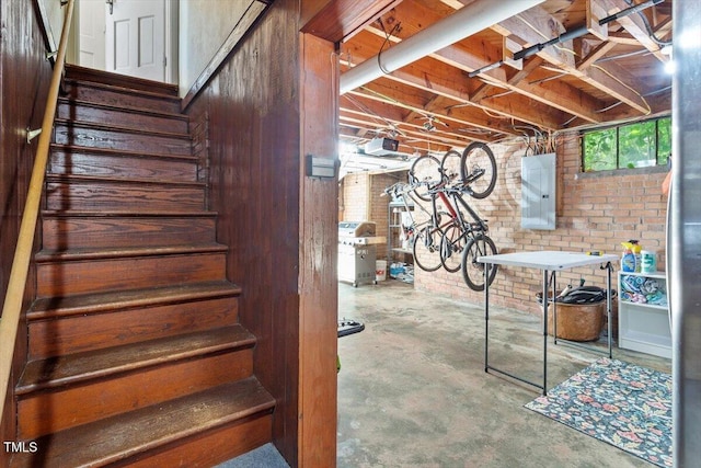 1100 Brooks Ave, Raleigh, NC 27607 - below grade area featuring electric panel, brick wall, and stairway