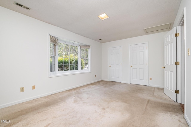 2213 Alpine Rd, Durham, NC 27707 - unfurnished bedroom with attic access, carpet, and multiple closets