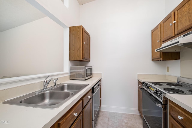 2213 Alpine Rd, Durham, NC 27707 - kitchen with appliances with stainless steel finishes, under cabinet range hood, light countertops, and brown cabinets
