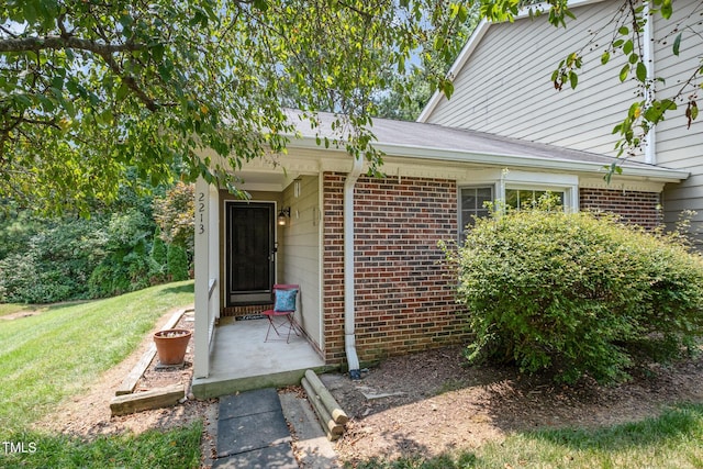 2213 Alpine Rd, Durham, NC 27707 - property entrance with brick siding and a yard