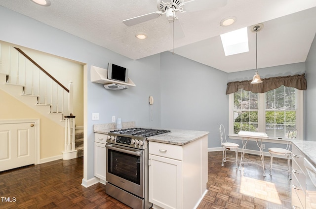 384 Lyndfield Cl W, Pittsboro, NC 27312 - kitchen with stainless steel range with gas cooktop, a skylight, white cabinetry, light stone countertops, and recessed lighting