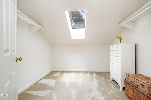 384 Lyndfield Cl W, Pittsboro, NC 27312 - walk in closet featuring a skylight, vaulted ceiling, and light carpet