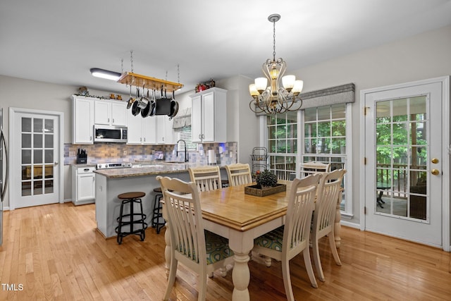 15 Smoketree Ct, Durham, NC 27712 - dining area featuring a chandelier and light wood finished floors