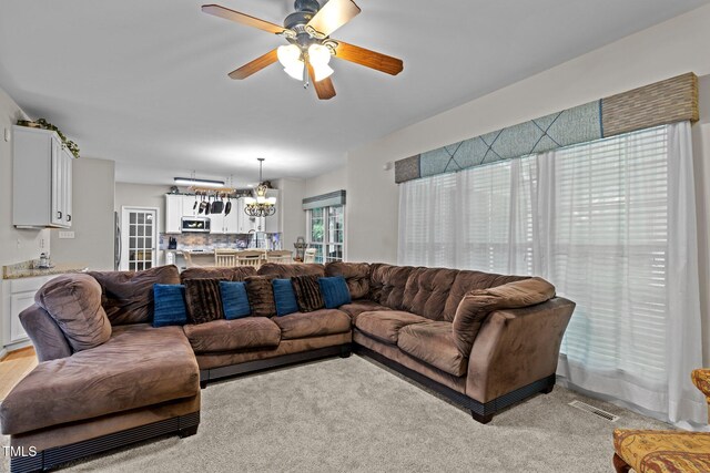 15 Smoketree Ct, Durham, NC 27712 - living area featuring a ceiling fan, a chandelier, and light colored carpet