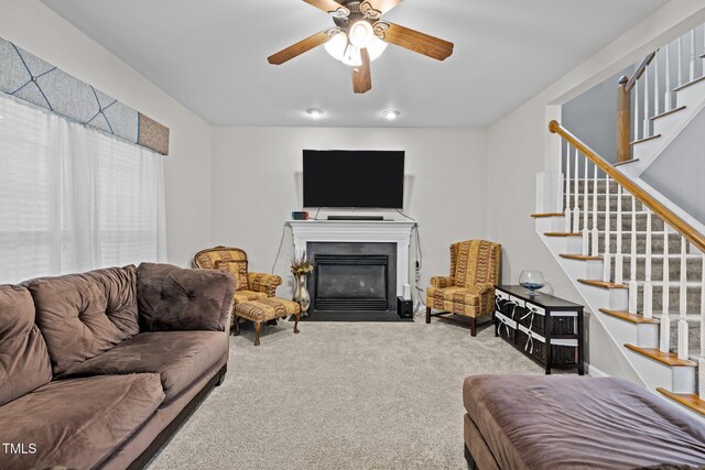 15 Smoketree Ct, Durham, NC 27712 - carpeted living room featuring stairway, a fireplace with flush hearth, and a ceiling fan