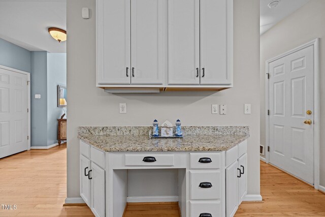 15 Smoketree Ct, Durham, NC 27712 - kitchen featuring light wood-style floors, white cabinetry, light stone counters, and built in desk